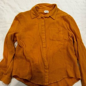 Mustard button up shirt.